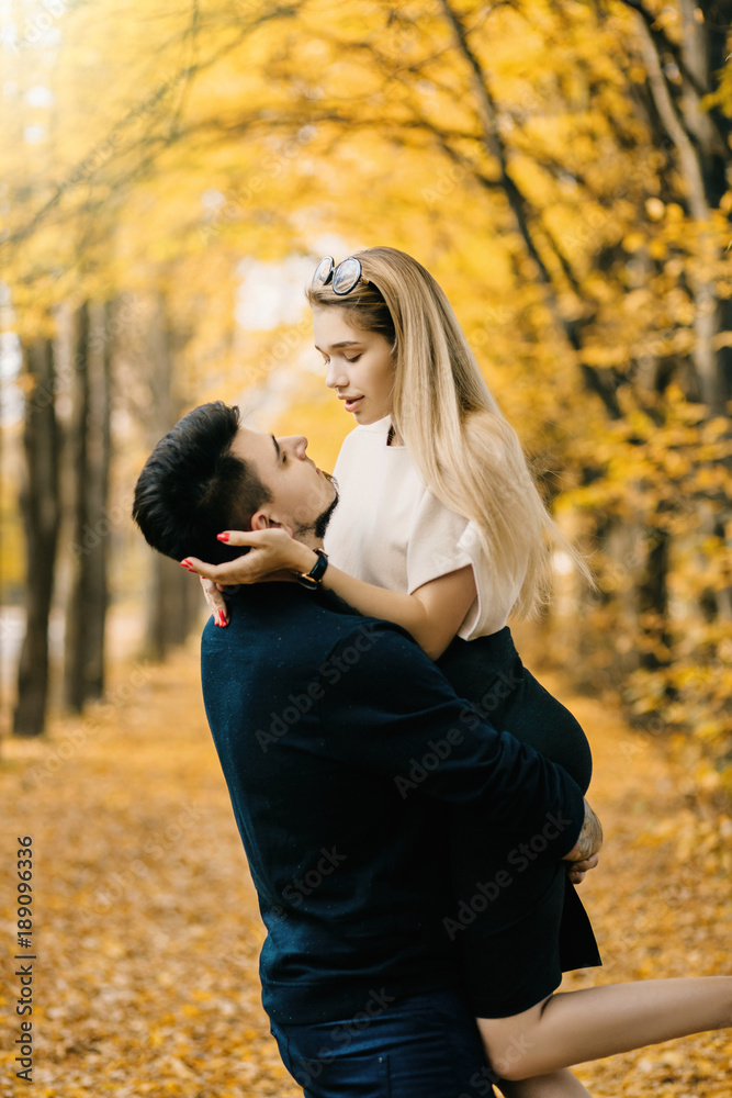 Young couple having fun in the autumn forest