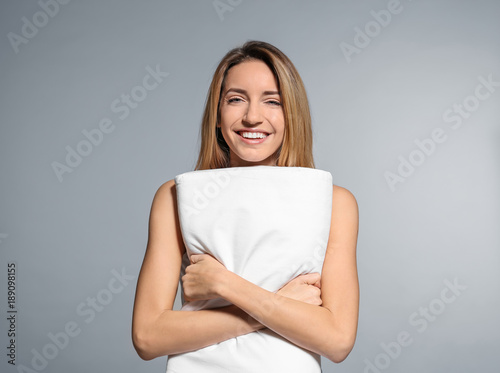 Young woman with soft pillo...