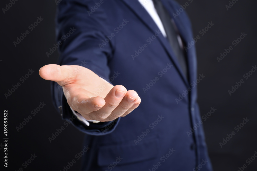 Fototapeta premium Businessman demanding bribe on black background