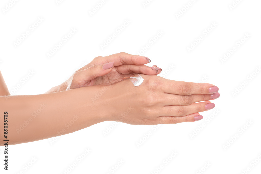 Woman applying hand cream on white background