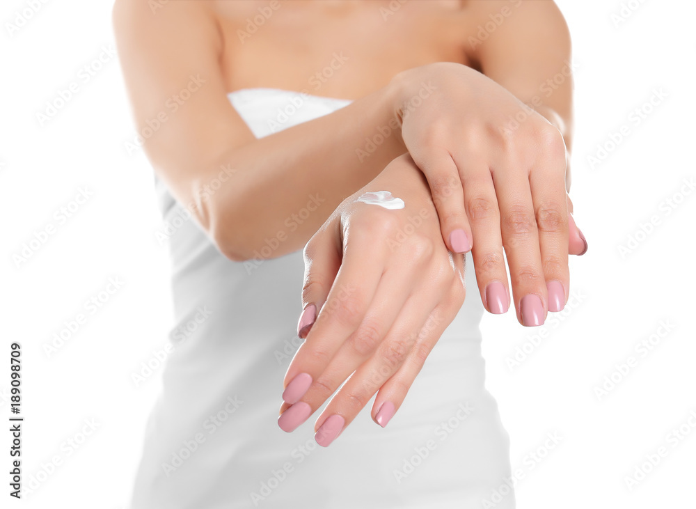 Young woman applying hand cream on white background, closeup Young woman applying hand cream on white background, closeup