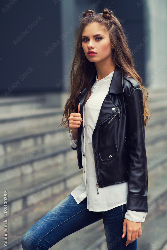 stylish young girl in a black kurta and jeans, a young girl with a trendy  hairstyle on the streets of the city Stock Photo | Adobe Stock