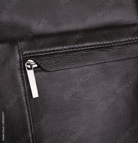 men's black bag; leather texture of a handbag close-up