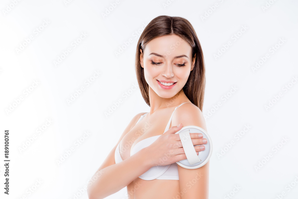 Purity clean clear soft smooth flawless fresh skin lifting cosmetics concept. Portrait of lovely beautiful cute girl using brush for applying scrub gel and doing massage isolated on white background Purity clean clear soft smooth flawless fresh skin lifting cosmetics concept. Portrait of lovely beautiful cute girl using brush for applying scrub gel and doing massage isolated on white background