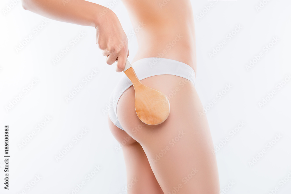 Smooth clean clear flawless soft neat slim underwear lingerie concept. Side  view cropped close up photo of slim beautiful thin woman's body, hand  holding wooden brush isolated on white background Photos