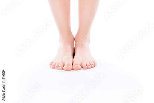 Fototapeta Naklejka Na Ścianę i Meble -  Cosmetics illness medicine vitality wellness size concept. Cropped close up photo of ideal perfect beautiful attractive woman's bare foot standing on white floor isolated on background copy-space