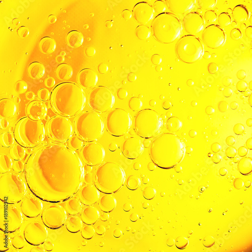 Yellow oil bubble on water.