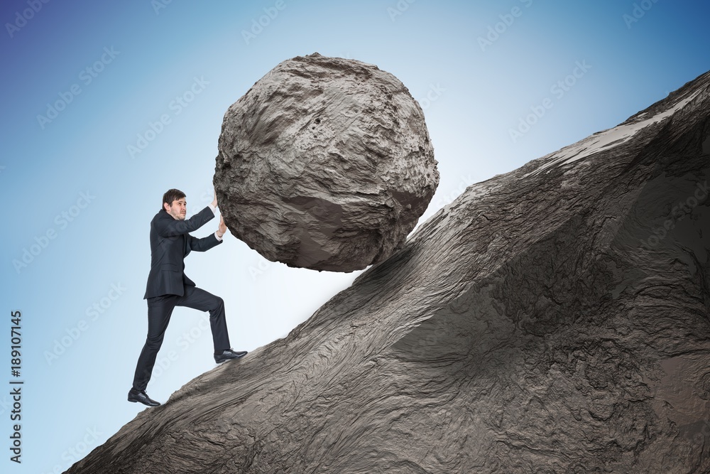 Sisyphus metaphore. Young businessman pushing heavy stone boulder up on
