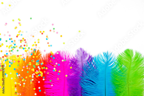 Bright colored feathers for a carnival costume. Color confetti. White background.