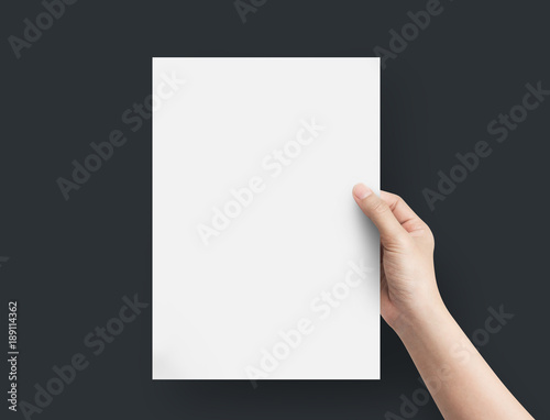 Woman hand holding blank paper sheet A4 size.