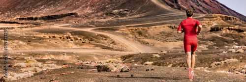 Athlete runnin on trail path, sports and fitness active lifestyle. Man runner on long distance run through desert summer landscape. Banner panorama crop of mountain background.