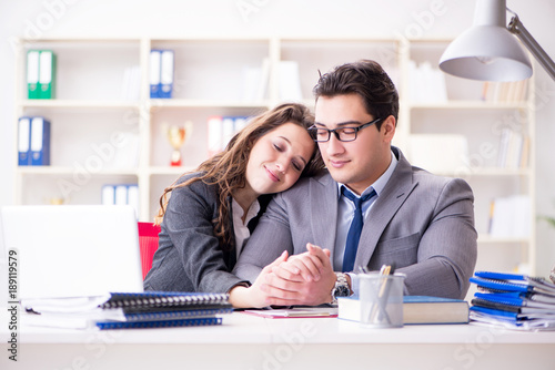 Happy couple working in the same office