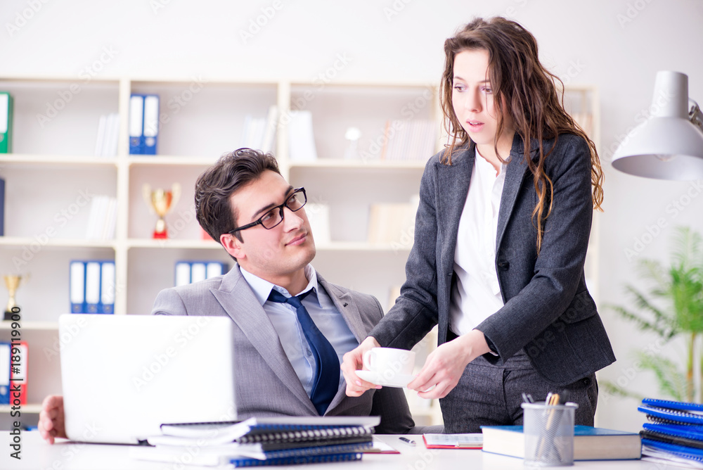 Unhappy boss having a chat with his secretary Unhappy boss having a chat with his secretary
