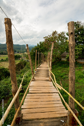 Wooden Bridge above the field of agriculture of farmer for walk across, Thailand landmark in North