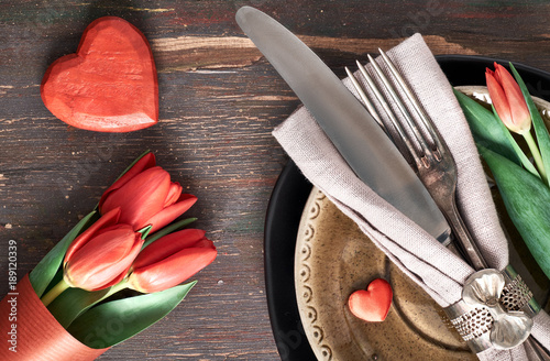 Springtime menu concept with fresh tulips and heart decoration on dark wood