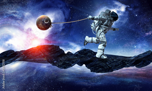 Fantasy image with spaceman catch planet. Mixed media