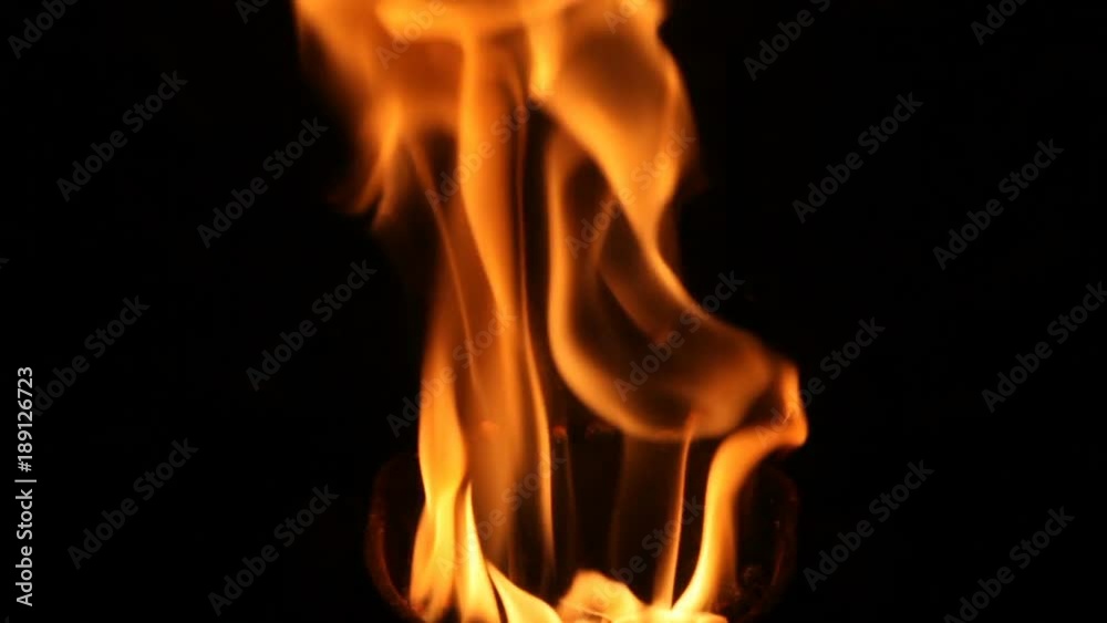 The flame of a stove burns in the crucible. The fire flares up and takes different colors depending on the fuel burned. The flame of a stove burns in the crucible. The fire flares up and takes different colors depending on the fuel burned.