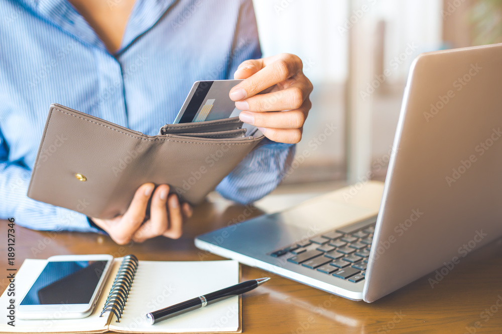 Women's hand Using a credit card, she pulled the card out of her wallet.