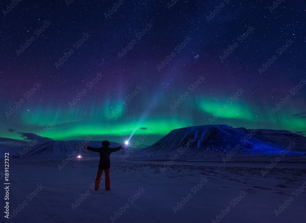 The polar arctic Northern lights aurora borealis sky star in Norway Svalbard in Longyearbyen city man mountains