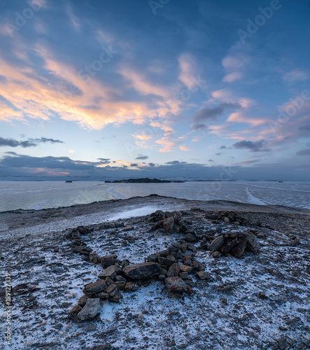 Cold winter sunrise on the shore of Lake Baikal photo