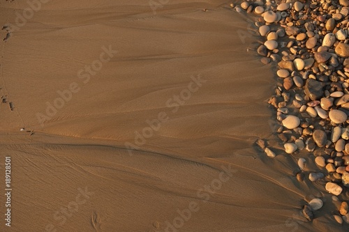 Small stones lying on the sandy beach