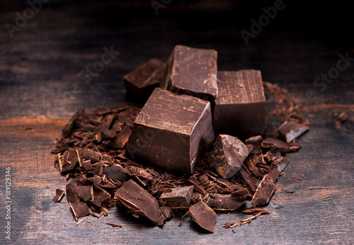 Pieces chocolate on a dark wooden background