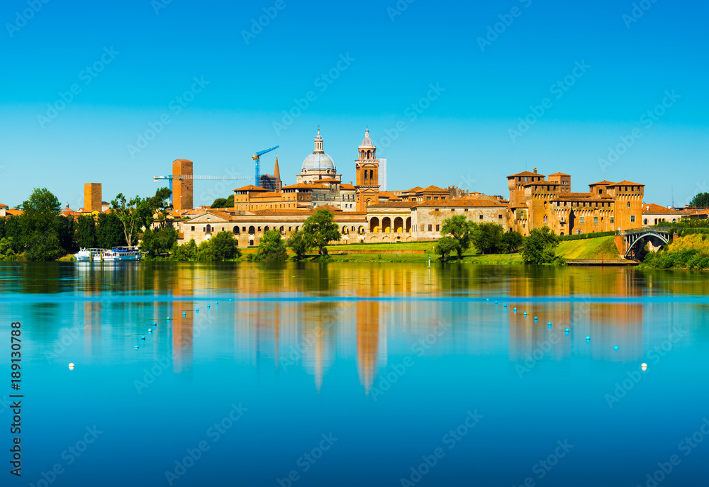 Mantova, Italy: Cityscape reflected in water. Old Italian town skyline. Province of Lombardy.