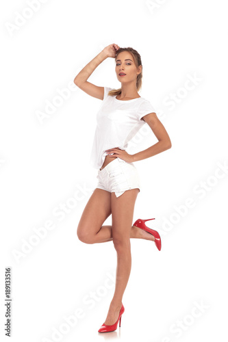 fahion woman in red high heels shorts and shirt posing