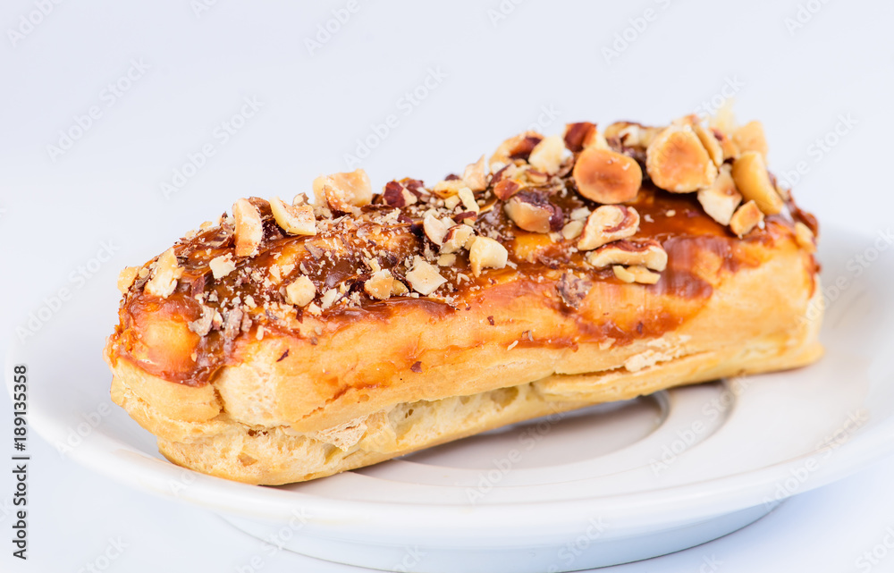Appetizing sweet dessert. Cupcake with cream and nuts on light background Appetizing sweet dessert. Cupcake with cream and nuts on light background