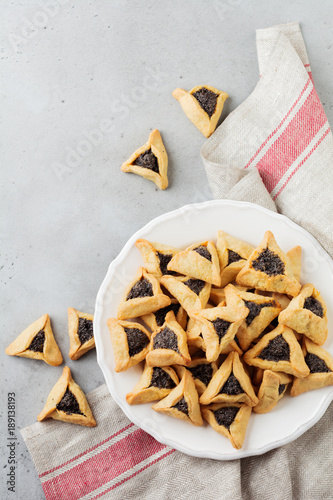 Traditional Jewish Hamantaschen cookies with berry jam. Purim celebration concept. Jewish carnival holiday background. Selective focus.Top voew. Copy space.