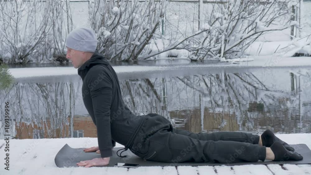 A man is meditating in nature in the winter. Yoga. A man is meditating in nature in the winter. Yoga.
