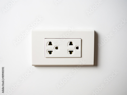 White socket 220 volts on white wall, unplugged