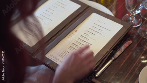Woman pointing at a menu, choosing what to eat