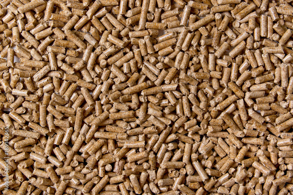 Biofuels. Alternative biofuel from sawdust. Wood pellets background. The cat litter.