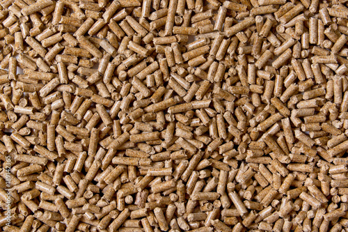 Biofuels. Alternative biofuel from sawdust. Wood pellets background. The cat litter.