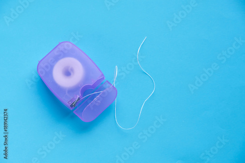 Dental floss on a blue background. caring for the oral cavity, caries