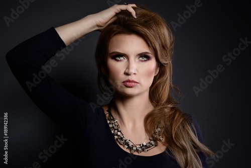 Studio beauty shot of woman with polished stone necklace.