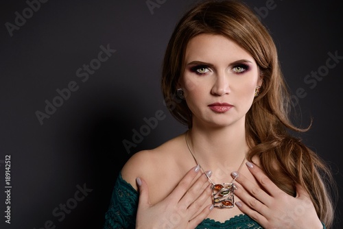 Studio beauty shot of woman with amber silver necklace and earrings