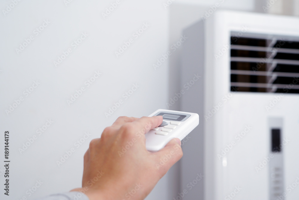 women hand is regulating the heater/air condition temperature