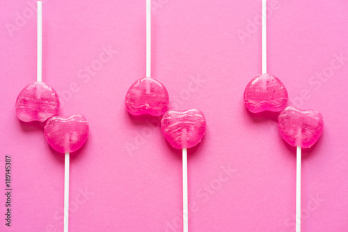 Set of candy hearts on a pink background. © GolubaPhoto
