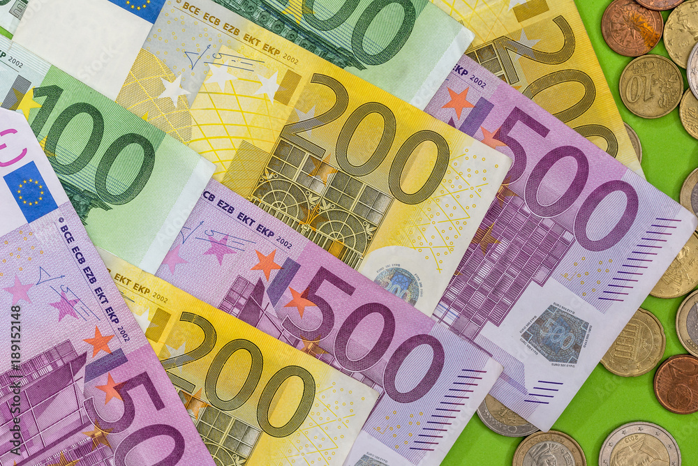 different euro banknotes and coin as background different euro banknotes and coin as background