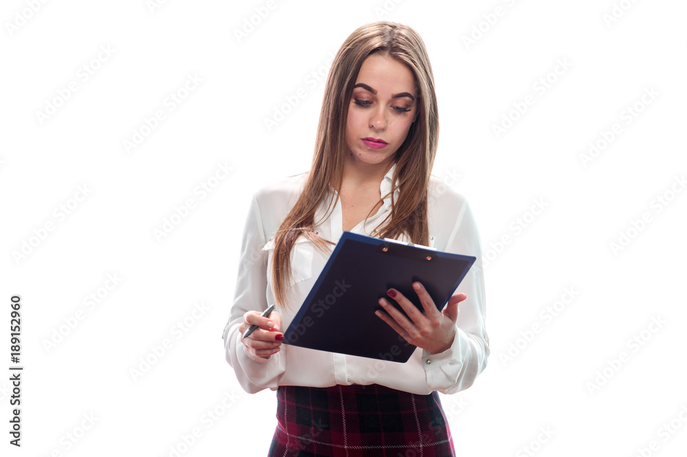 Woman interviewer. Charming young woman looks at the folder with papers and pen to poll the public. Place for text Woman interviewer. Charming young woman looks at the folder with papers and pen to poll the public. Place for text