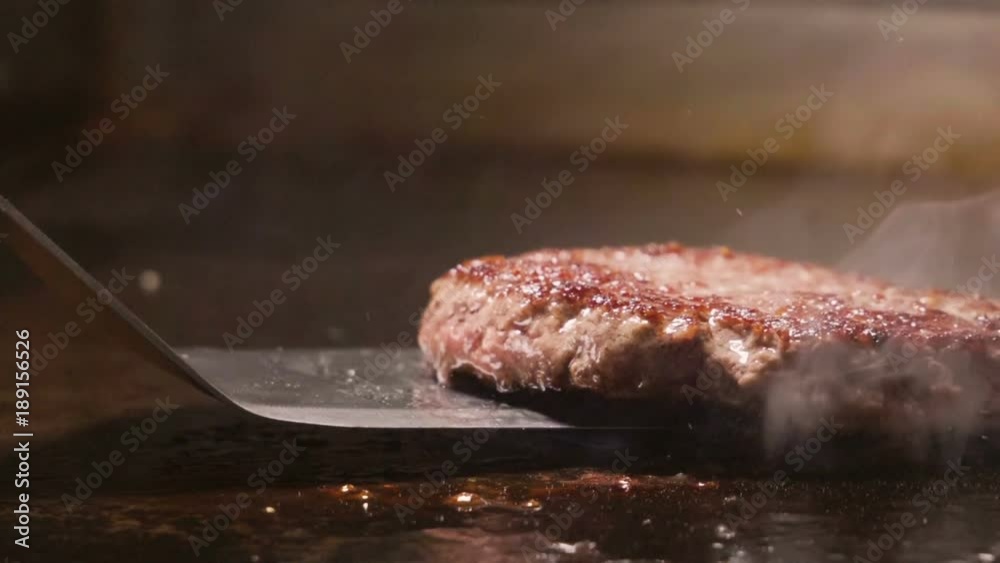 Cooking beef and pork patty for burger. Meat roasted at kitchen. Slow motion. HD