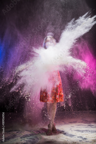 Young girl during photoshoot with flour