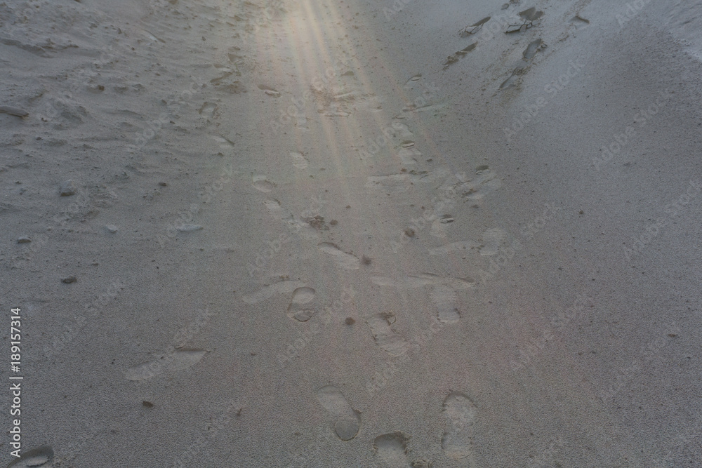 Human footsteps in sandy desert dunes . Human footsteps in sandy desert dunes .