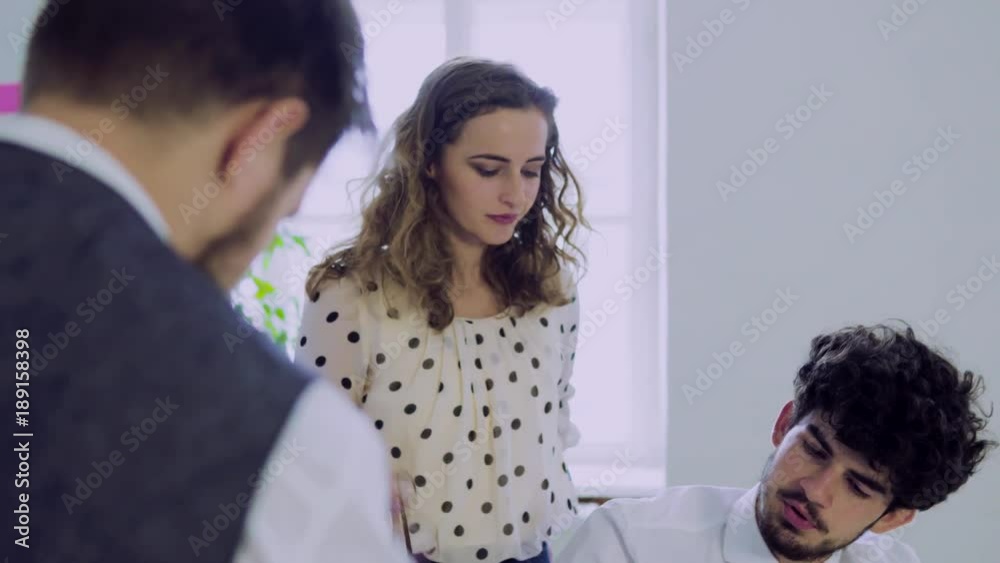Group of young people working together in an office. Group of young people working together in an office.