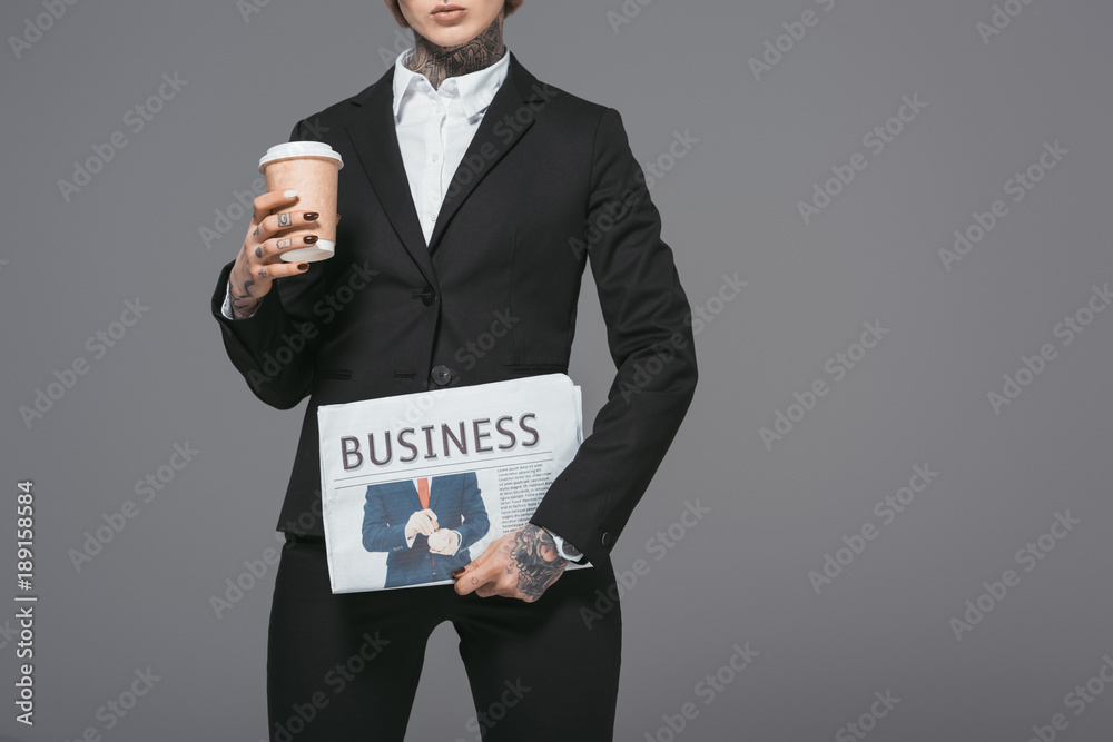 cropped view of businesswoman with coffee to go and newspaper, isolated on grey cropped view of businesswoman with coffee to go and newspaper, isolated on grey