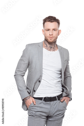 young tattooed businessman in grey suit, isolated on white