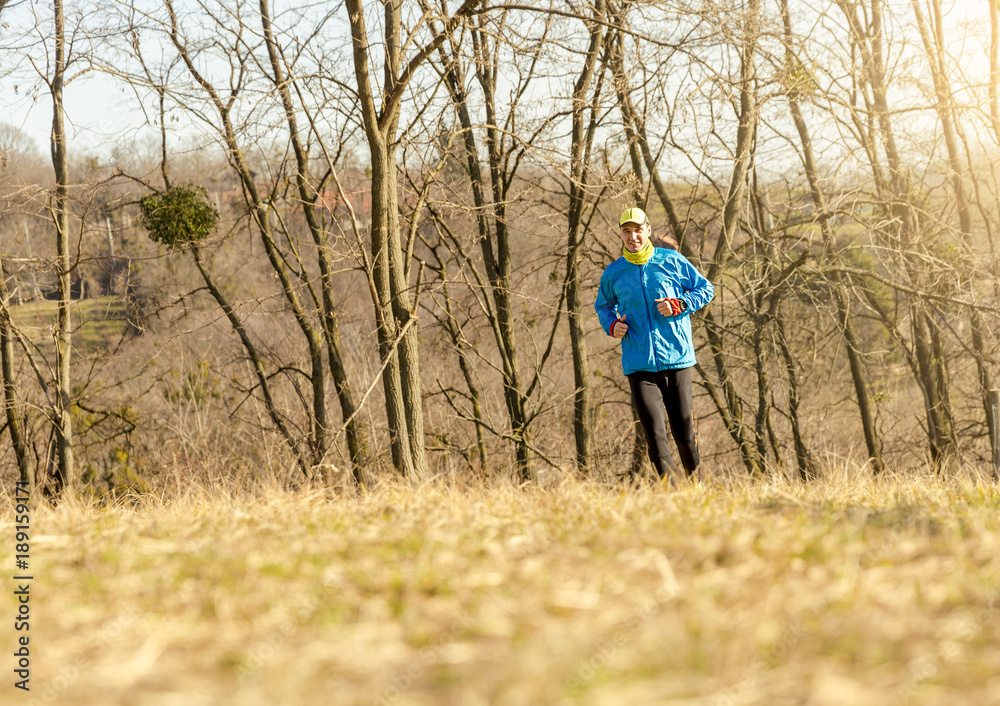 Athletic young man running in the nature. Healthy lifestyle