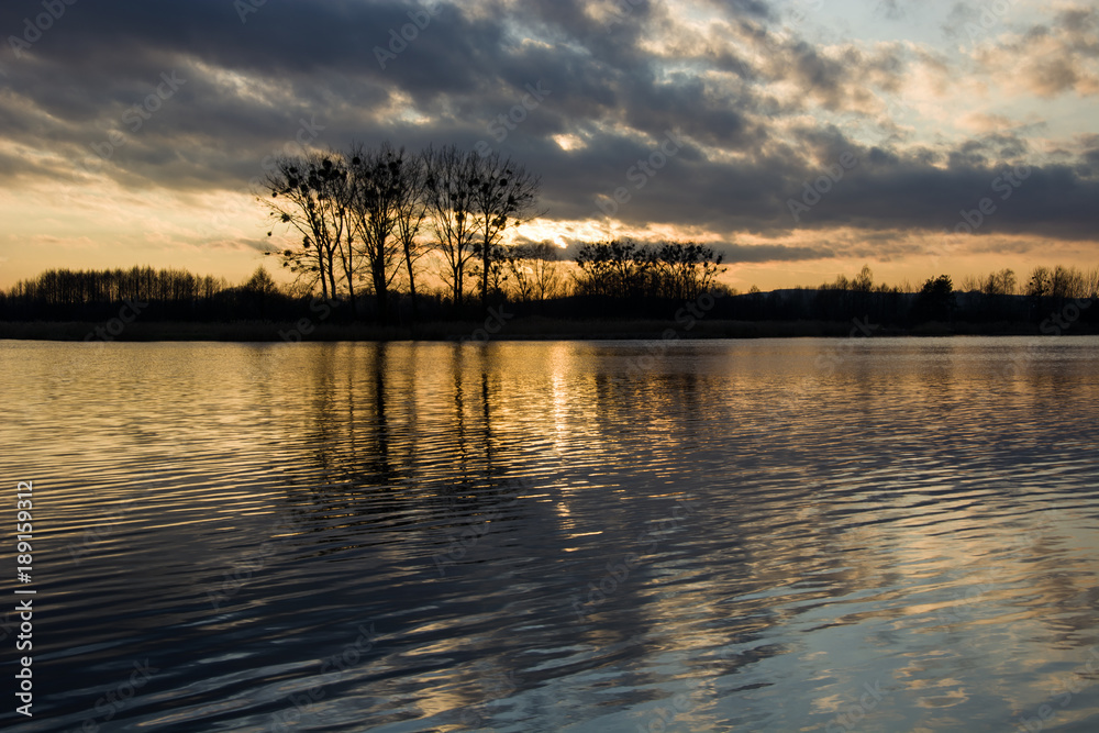 Dark clouds and sunset on the lake Dark clouds and sunset on the lake